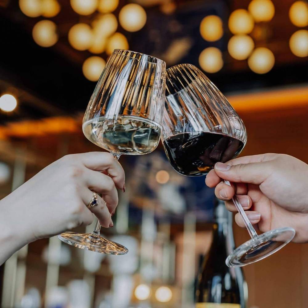 Red and white wine Wine glasses held high